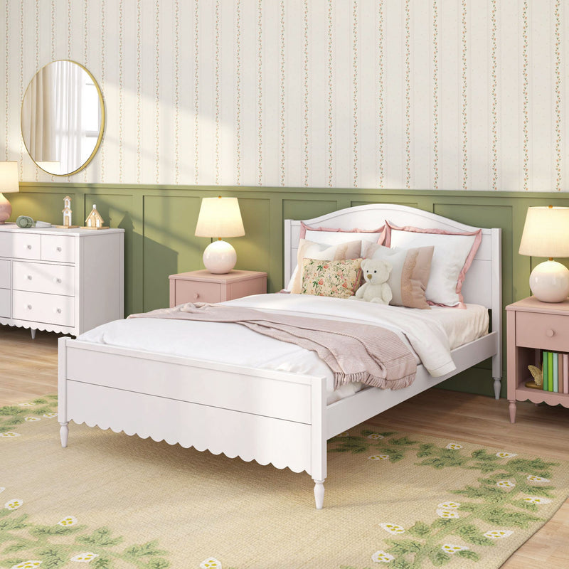Cozy children's bedroom with white wooden bed, pink bedding and floral pillows, green wainscoting, vertical floral wallpaper, round mirror, bedside lamps and teddy bear