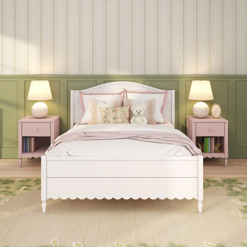 Girls bedroom with white bed, pastel pink bedding, floral pillows and teddy bear, green wainscoting and pink nightstands