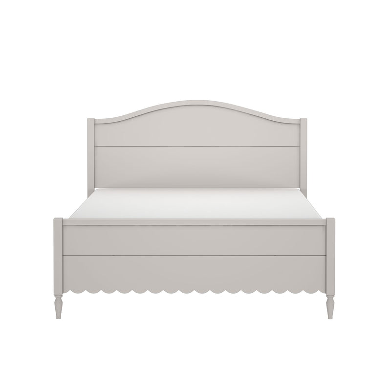 Beige wooden farmhouse bed frame with curved arched headboard, scalloped apron, turned legs and mattress