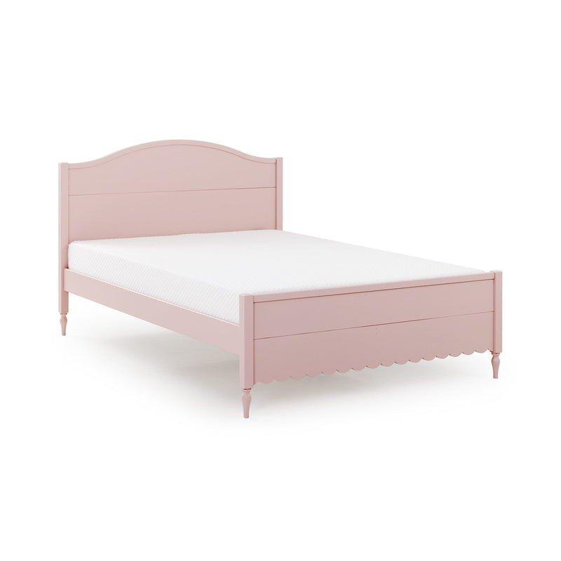 Pink twin bed frame with curved headboard, scalloped trim and turned legs with white mattress