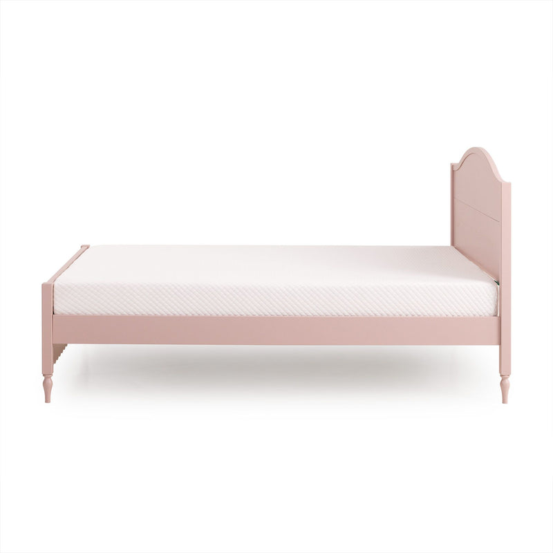 Pink wooden twin bed with scalloped headboard and white quilted mattress, kids' bedroom furniture, classic modern design