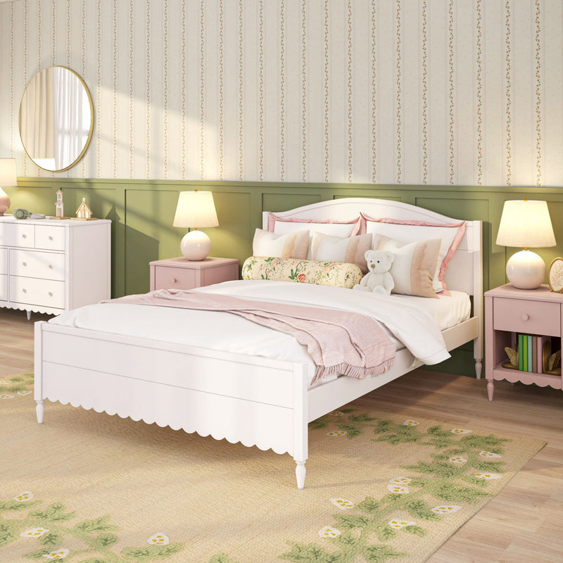 Cozy pastel children's bedroom with white wooden bed, pink bedding and pillows, floral bolster and teddy bear, green wainscoting, striped floral wallpaper, round wall mirror and bedside lamps — kids bedroom decor