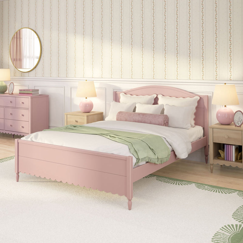 Pink pastel girls' bedroom interior with scalloped wooden bed, white bedding and green throw, floral striped wallpaper, pink dresser and round mirror