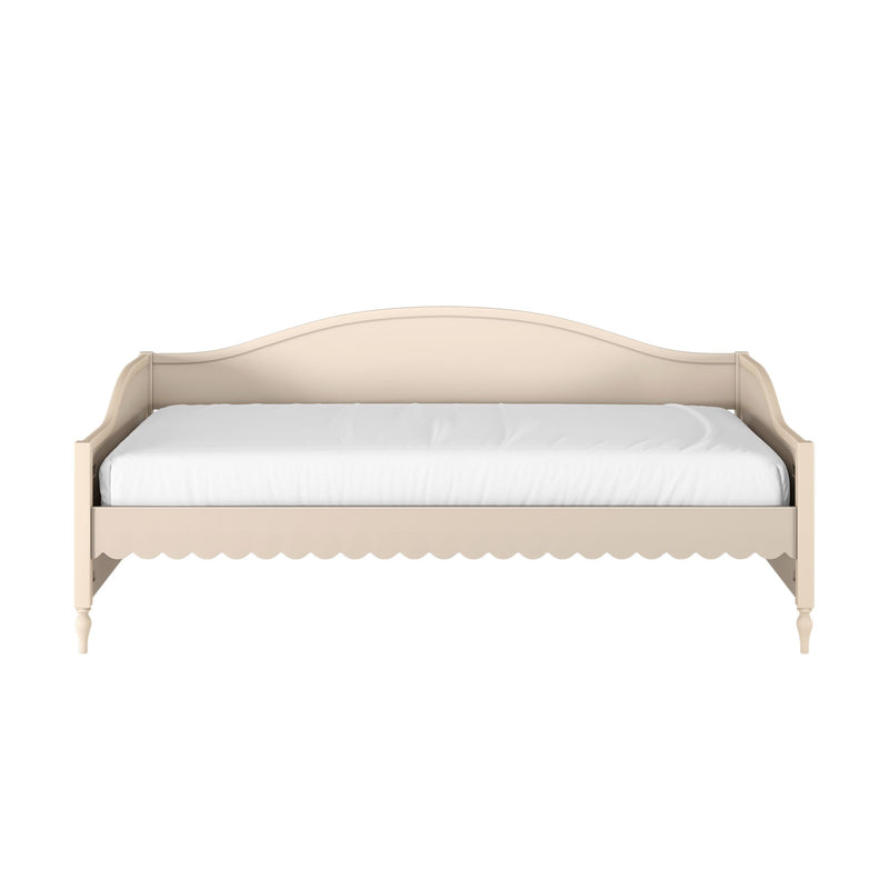 Cream wooden daybed with curved headboard, scalloped apron trim and white mattress — farmhouse-style twin bedroom bed