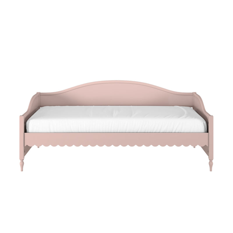 Pink wooden twin daybed with curved headboard, scalloped trim, turned legs and white mattress, vintage-style children's bed