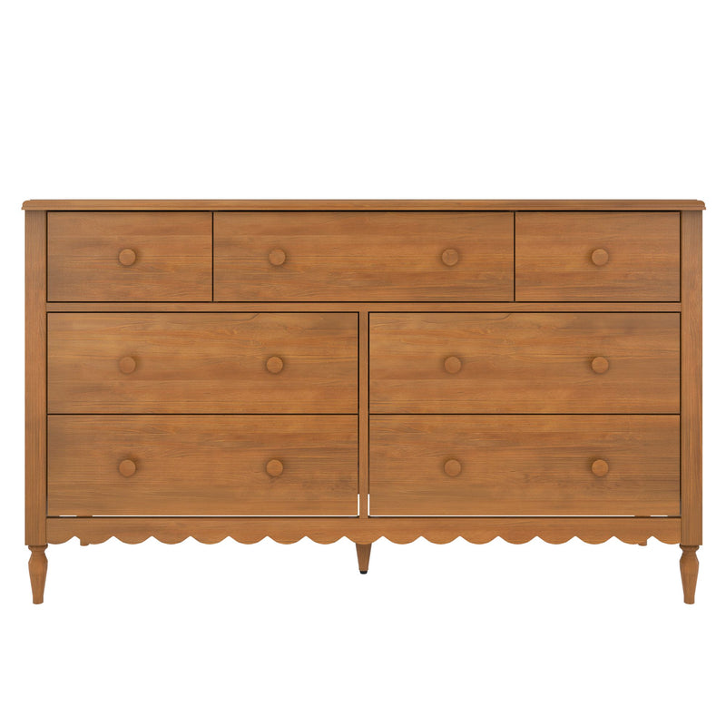 Brown wooden dresser with multiple drawers and round wooden knobs, scalloped apron and turned legs — rustic farmhouse bedroom dresser for storage with warm wood grain finish
