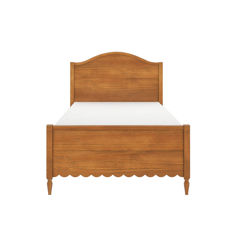 Honey oak wooden twin bed frame with arched headboard, scalloped footboard, turned legs and white mattress on white background