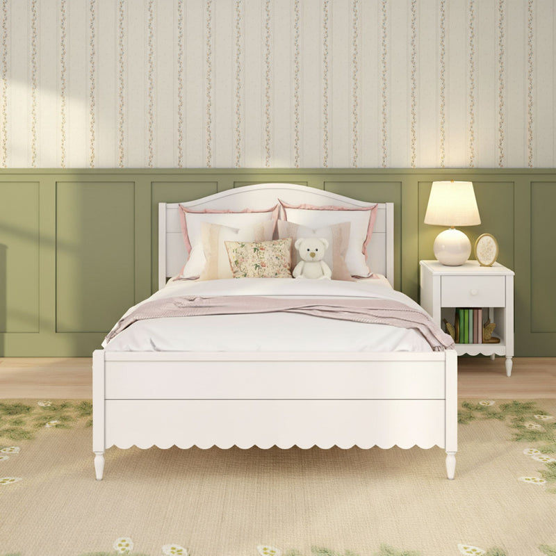 Girls bedroom interior design: white wooden bed with pastel floral pillows and teddy bear, white nightstand and lamp, olive green wainscoting and striped floral wallpaper