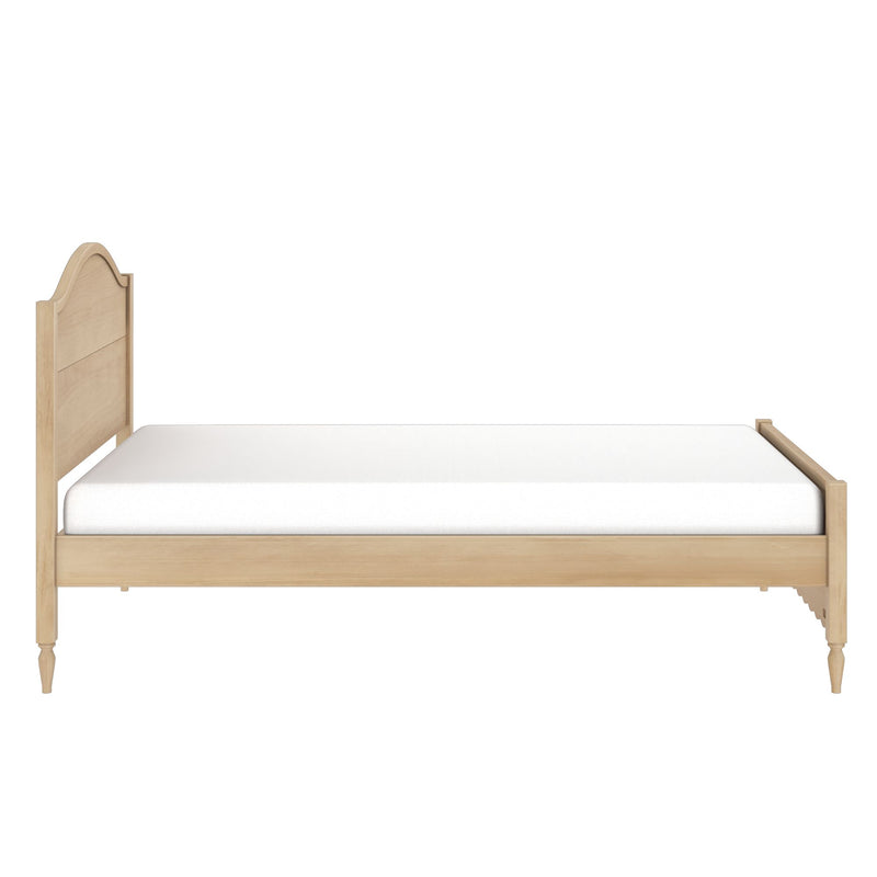 Light wood twin bed frame with arched carved headboard, turned legs and white mattress isolated on a white background
