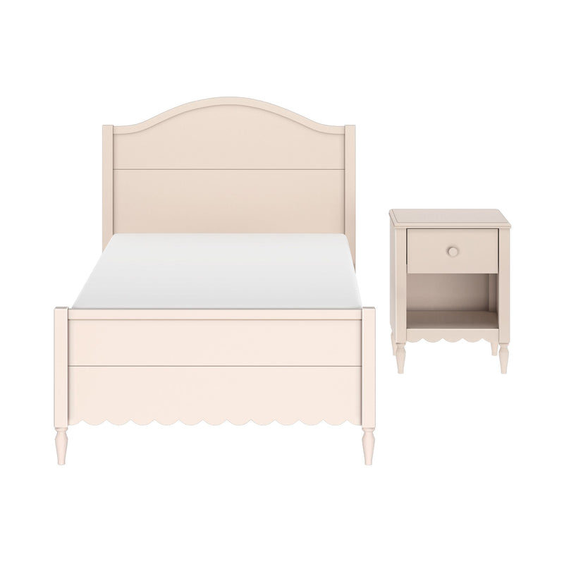 Pastel pink wooden twin bed with arched headboard and scalloped footboard beside matching nightstand – shabby chic kids' bedroom furniture set