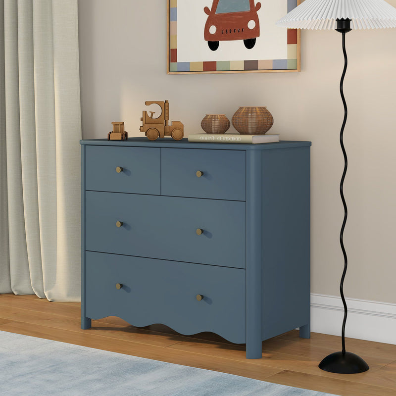 Blue dresser in children's nursery with wooden toy trucks, rattan baskets, framed car wall art, neutral curtains and modern black floor lamp