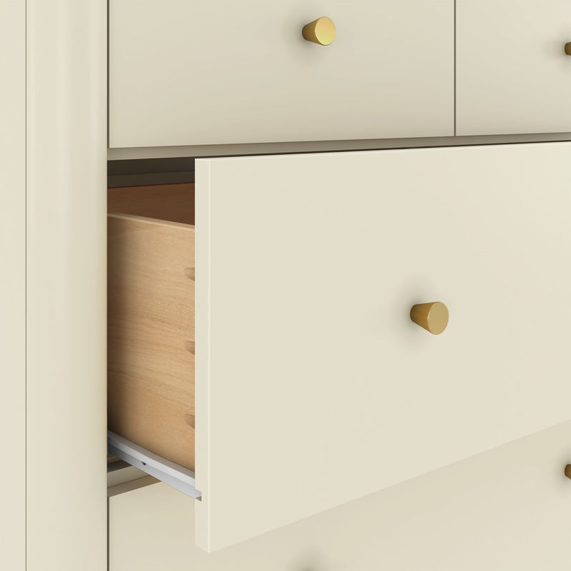 Close-up of cream dresser drawers partially open showing natural wood interiors, metal drawer slides and round brass knobs, modern bedroom storage detail
