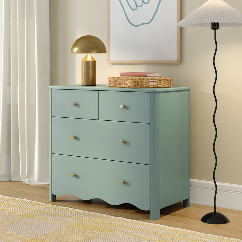 Mint green dresser with brass mushroom table lamp, woven storage basket and books in modern neutral bedroom decor