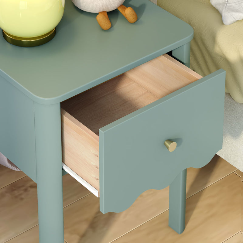 Teal bedside table with open wooden drawer and brass knob, lamp and stuffed toy on top on hardwood floor — modern vintage nightstand for bedroom