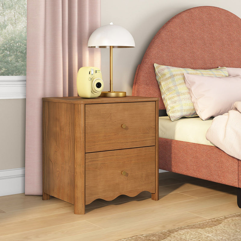Wooden two-drawer nightstand beside upholstered pink bed with white dome table lamp and yellow instant camera