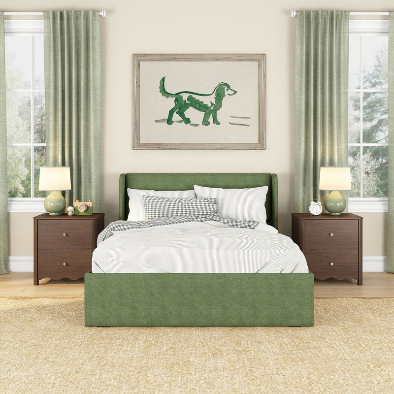 Green upholstered bed in cozy modern bedroom with green curtains, wooden nightstands, bedside lamps and framed dog artwork