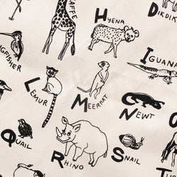 Illustrated animal alphabet fabric with animals like giraffe, hyena, lemur, and meerkat.