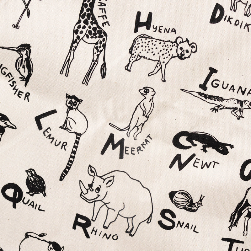 Illustrated animal alphabet fabric with animals like giraffe, hyena, lemur, and meerkat.