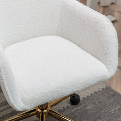 Luxurious white boucle office chair with gold legs on a textured rug in a modern home office setting.