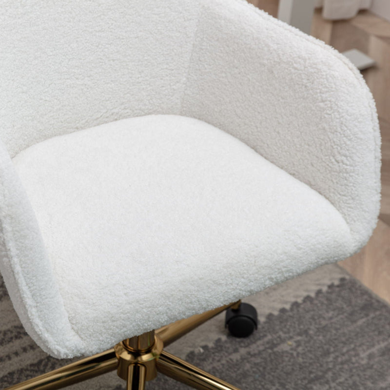 Luxurious white boucle office chair with gold legs on a textured rug in a modern home office setting.