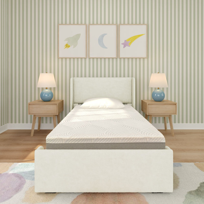 Children's bedroom with upholstered twin bed, wooden nightstands, blue lamps, green striped wallpaper, and rocket, moon, star framed art