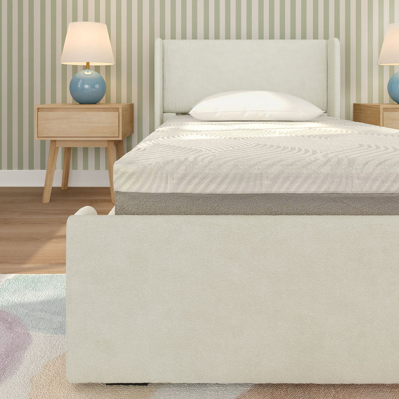 Minimal modern bedroom with cream upholstered bed frame and mattress, mid-century wooden nightstands, blue ceramic lamps and green striped wallpaper