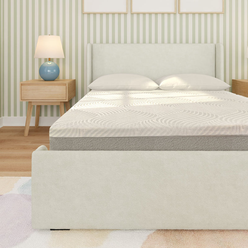 Modern minimalist bedroom interior with light gray upholstered bed and headboard, white patterned mattress and pillows, wooden nightstand with blue ceramic lamp, green-and-white striped wallpaper and hardwood floor