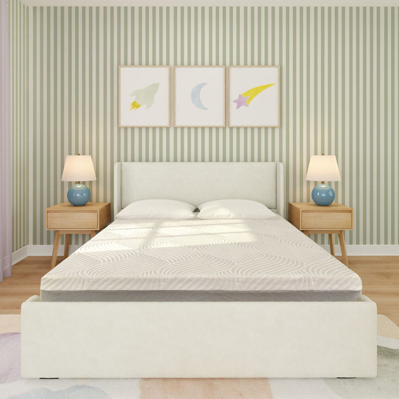 Bright children's bedroom with white upholstered bed and mattress, green vertical-striped wallpaper, wooden nightstands with blue table lamps, and framed rocket, moon and star wall art