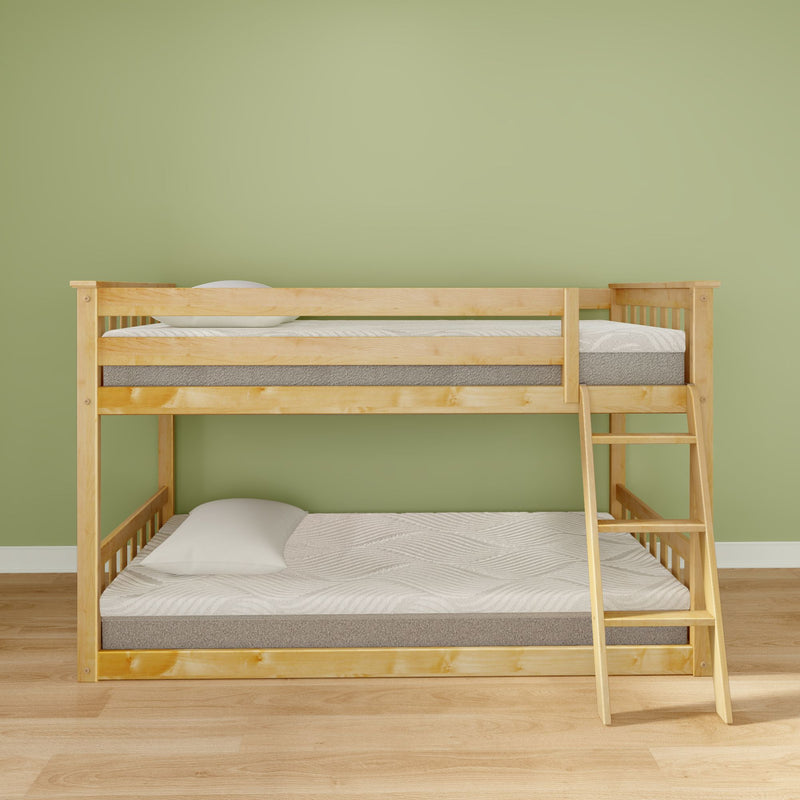 Natural wood bunk bed with ladder, twin mattresses and pillows in a minimalist kids' bedroom with green wall and hardwood floor, space-saving design