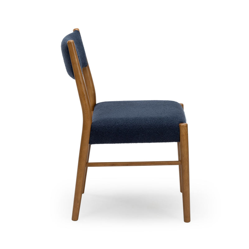 Side view of mid-century modern wooden dining chair with textured navy upholstered seat and back on white background