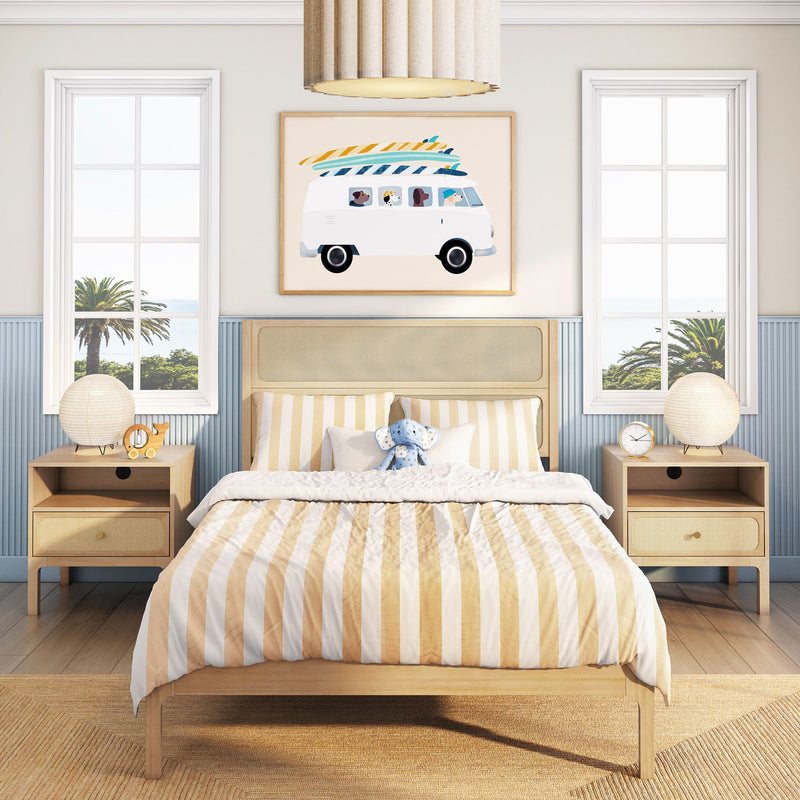 Beach-themed kids bedroom with striped beige bedding, natural rattan headboard, surfboard-van wall art, wooden nightstands and palm-tree window view