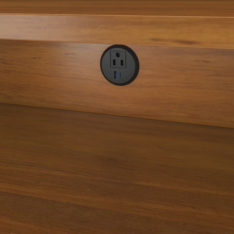 Recessed round desk power outlet with US AC socket and USB-A and USB-C charging ports mounted in a wooden desk