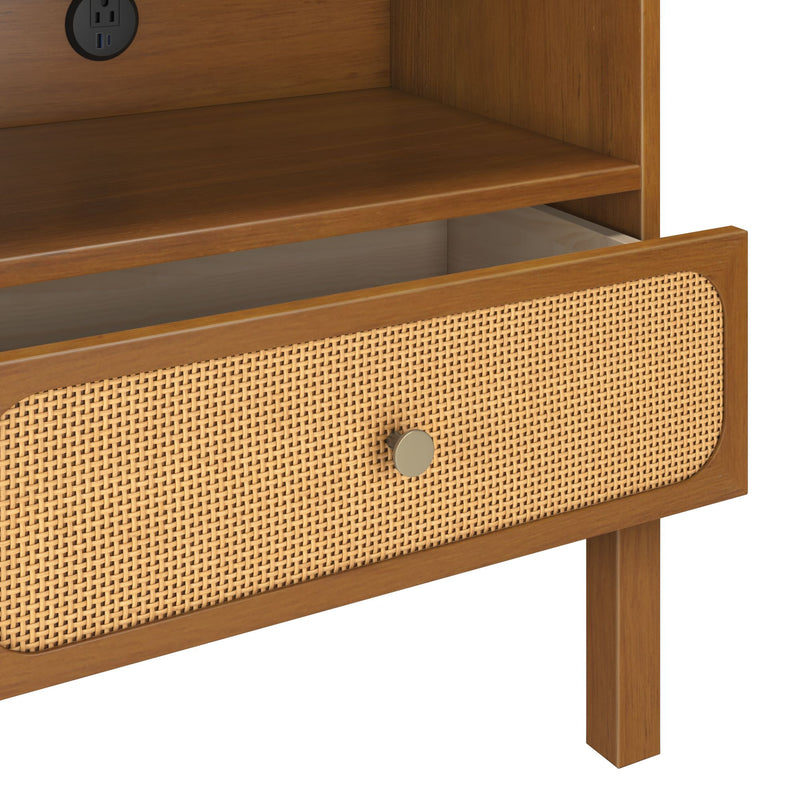 Mid-century modern light wood nightstand with woven cane rattan drawer front, round brass knob, open drawer and built-in power outlet
