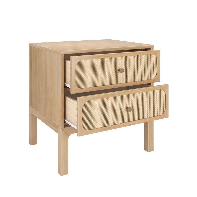 Light natural wood two-drawer nightstand bedside table with woven rattan cane drawer fronts, brass knobs and tapered legs — mid-century modern bedroom storage