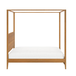Four-poster wooden bed frame with white mattress showcasing minimalist bedroom furniture design.