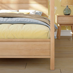 Wooden bed frame with comfortable bedding in a stylish bedroom setting.