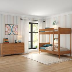 Modern children's bedroom with wooden bunk bed, colorful striped walls, and dresser with books.