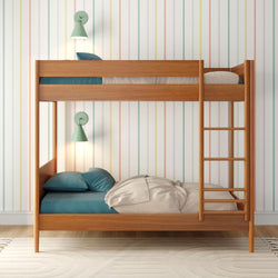 Wooden bunk bed with teal pillows and pastel striped wallpaper, perfect for a modern children's bedroom.