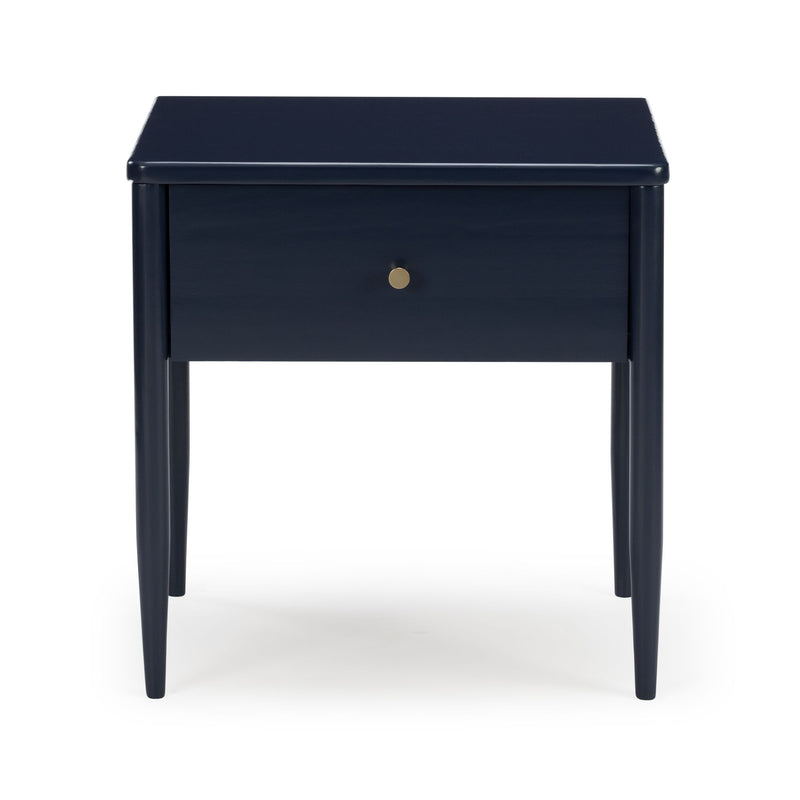 Navy blue mid-century modern wooden nightstand bedside table with tapered legs, single drawer and brass knob on white background.