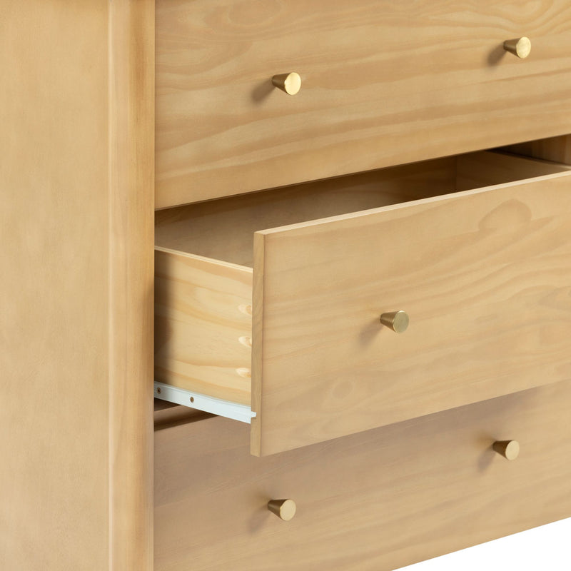 Light natural wood dresser with open drawer and brass knobs, smooth finish and dovetail joints for bedroom storage