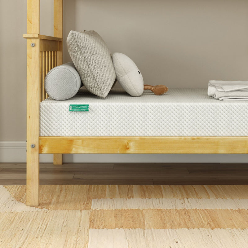 8-inch gel memory foam mattress on light wood platform bed with neutral pillows, bolster, and beige area rug