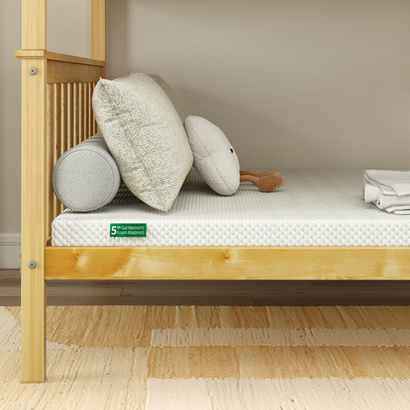 5-inch gel memory foam mattress on light wood toddler bed with quilted white cover, bolster pillow, square cushion and plush toy in nursery