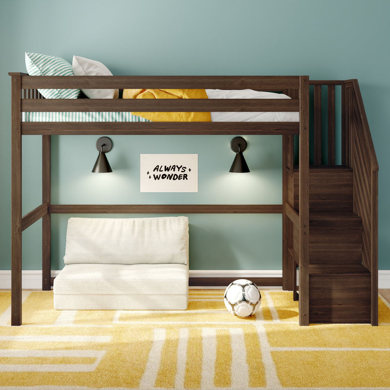 Kids loft bed with stairs in modern teal bedroom, dark wood bunk, under-bed lounge with white sofa, striped pillows, yellow blanket, geometric rug and soccer ball