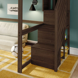 Dark wood loft bed with built-in staircase and storage cubbies in a kids' bedroom featuring a teal accent wall, yellow geometric rug, white sofa and soccer ball