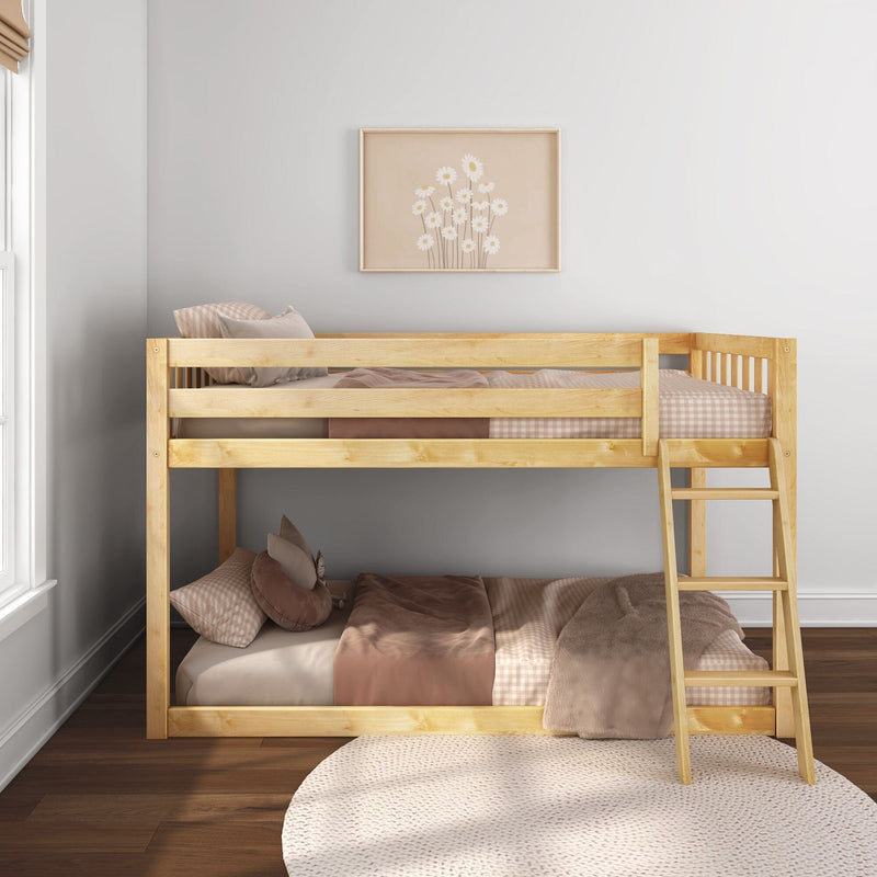 Wooden bunk bed in a neutral kids' bedroom with pink-beige bedding, ladder, round knit rug and framed daisy wall art