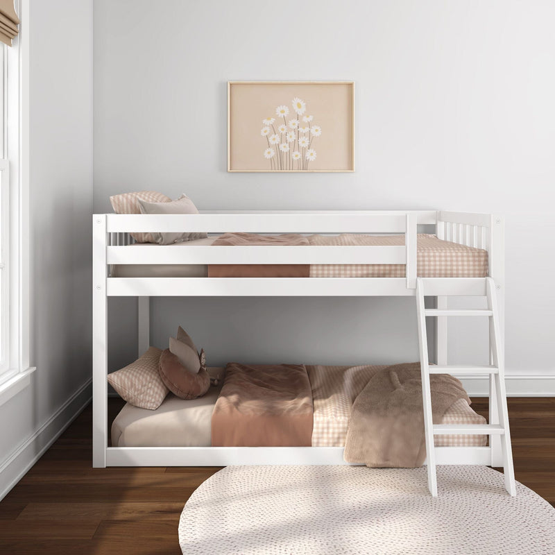 White wooden bunk bed in a neutral nursery with pink-beige gingham bedding, plush pillows and framed daisy wall art