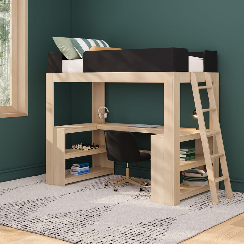 Light‑wood loft bed with built‑in desk and ladder in a modern kids’ bedroom, black safety rail and striped pillows atop, tucked workspace with swivel chair, laptop, headphones and shelving against a dark green accent wall