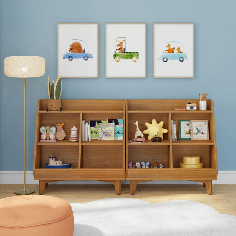 Kids nursery with light blue accent wall, wooden toy shelf filled with plush toys and books, and three framed watercolor animal car prints (bear, moose, fox)