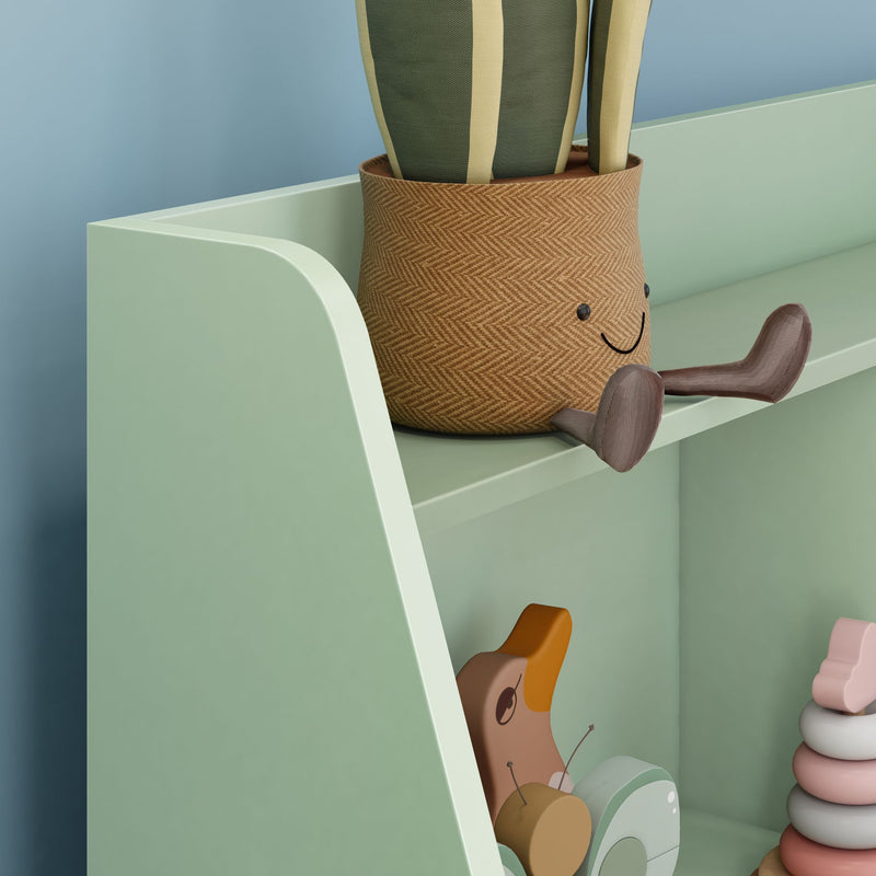Pastel mint green children's bookshelf holding a smiling woven plant pot, wooden pull-along duck toy and pastel stacking rings, ideal nursery decor and toy storage