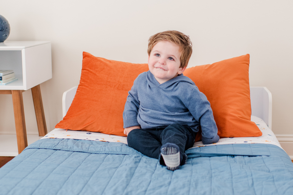 Floor Platform Twin Bed with young boy and nightstand 
